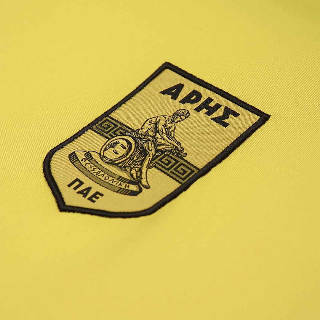 Maillot Kombat XXV Aris FC 25/26 Jaune Homme main